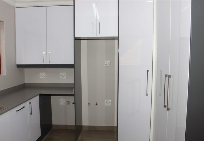 New Kitchen done in Gloss Iceberg White and Gloss Storm Grey melamine and Grey Quartz tops