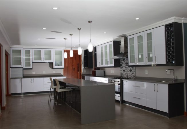 New Kitchen done in Gloss Iceberg White and Gloss Storm Grey melamine and Grey Quartz tops Frosted glass doors