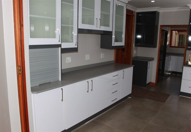 New Kitchen done in Gloss Iceberg White and Gloss Storm Grey melamine and Grey Quartz tops Frosted glass doors