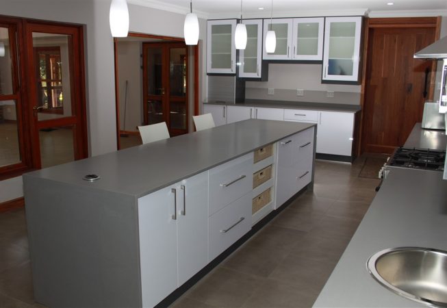New Kitchen done in Gloss Iceberg White and Gloss Storm Grey melamine and Grey Quartz tops Frosted glass doors