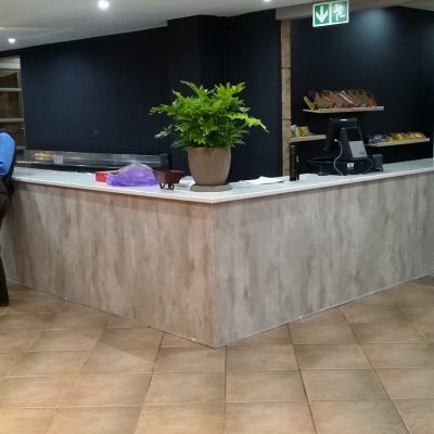 Shopfitting in Natural Concrete melamine with Kristal Gloss formica top