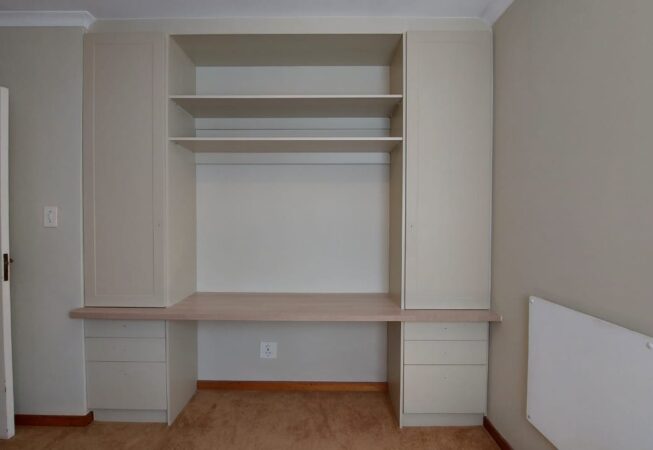 Built-in study desk and cupboards in Cappuccino melamine and wrap doors with 32mm Shale Oak top