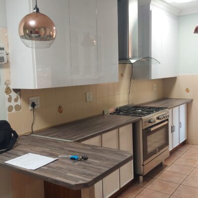 Kitchen revamp done in Iceberg white top cupboards with Woodland Fusion countertops