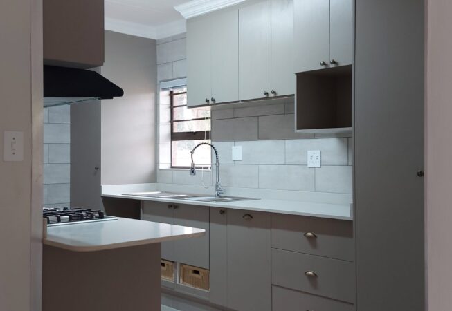 Kitchen revamp in Congo melamine and Vanilla quartz tops