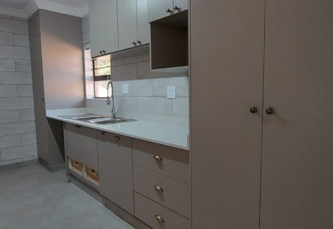 Kitchen revamp in Congo melamine and Vanilla quartz tops