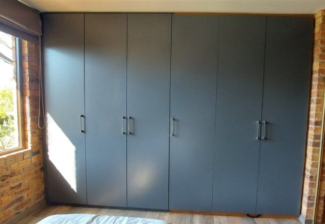 Bedroom cupboards installation using Storm Grey melamine.