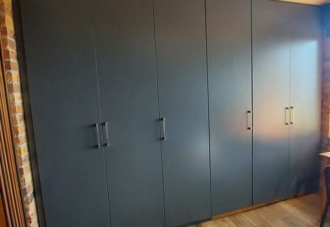 Bedroom cupboards installation using Storm Grey melamine.