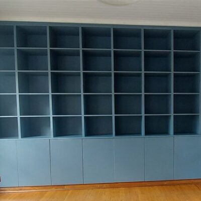 Bookshelf installation using Petrol Blue melamine with 4 drawer unit in white melamine