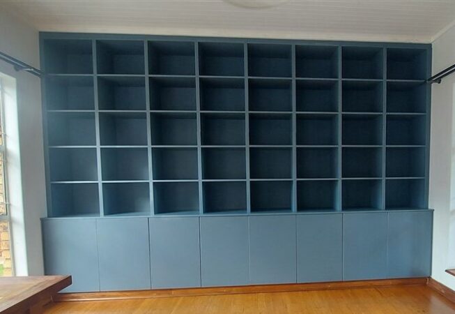 Bookshelf installation using Petrol Blue melamine with 4 drawer unit in white melamine