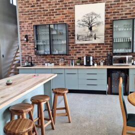 New kitchen installation using Caraz and Vermont Slate melamine with solid Maple tops. Glass wall units with LED lighting inside.