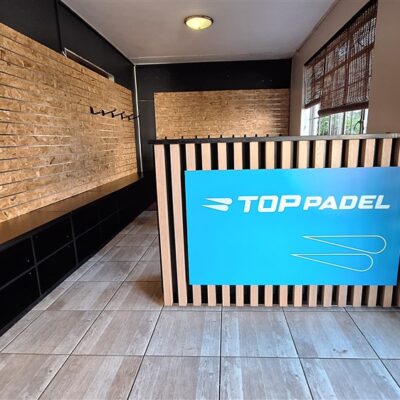 Shopfitting; OSB slatwall panels with Black melamine cupboard and Zimbabwe Black granite