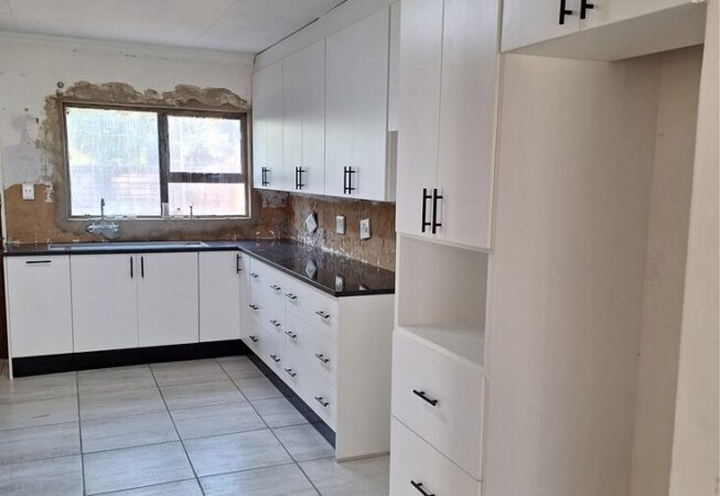 Kitchen revamp using white melamine with Rustenburg granite worktops.