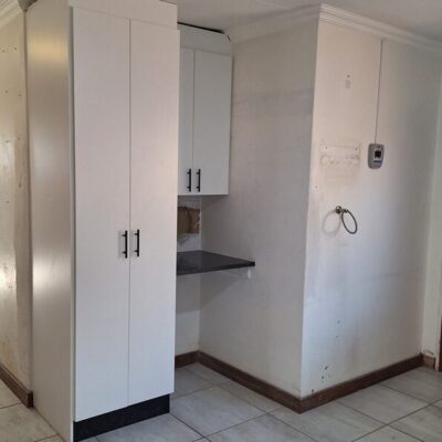 Kitchen revamp using white melamine with Rustenburg granite worktops.