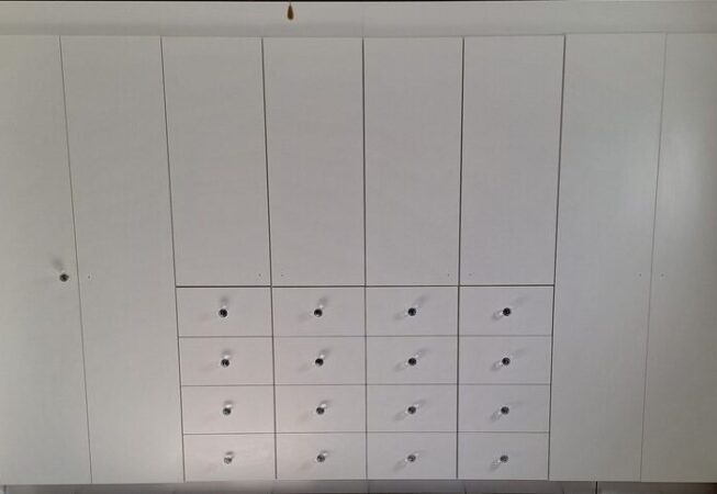 Bedroom cabinets in White melamine with custom-made drawers.