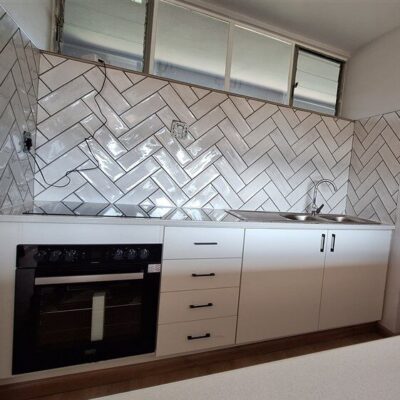 Kitchen revamp using white melamine with Rustenburg granite worktops.
