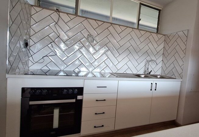 Kitchen revamp using white melamine with Rustenburg granite worktops.