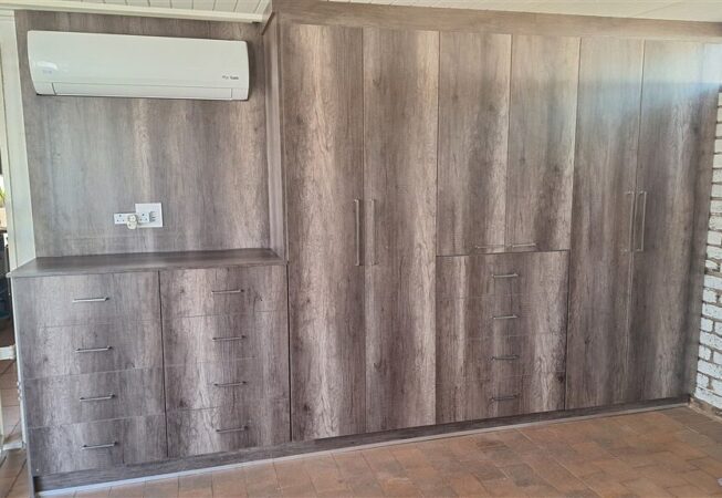 Wall unit in Monument Oak and white melamine interior.