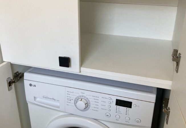 Bathroom cupboard using white melamine with space for a washing machine