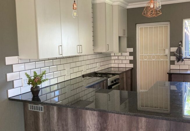 Kitchen revamp using Monument Oak and Folkstone Grey melamine and Rustenburg Granite Tops