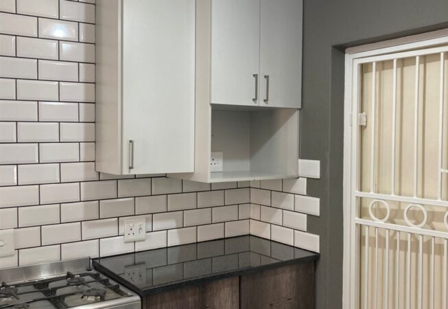 Kitchen revamp using Monument Oak and Folkstone Grey melamine and Rustenburg Granite Tops