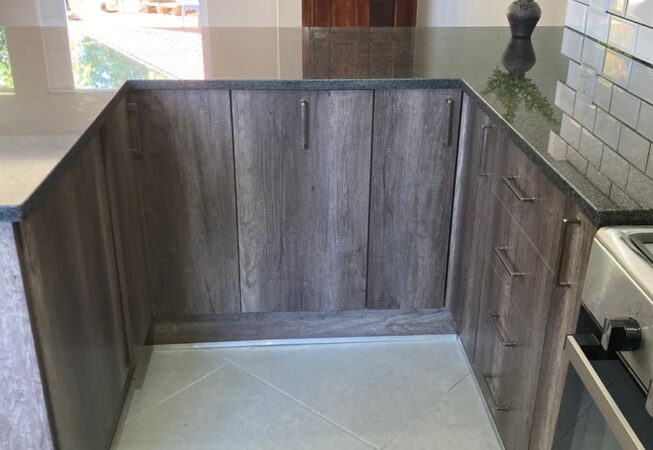 Kitchen revamp using Monument Oak and Folkstone Grey melamine and Rustenburg Granite Tops
