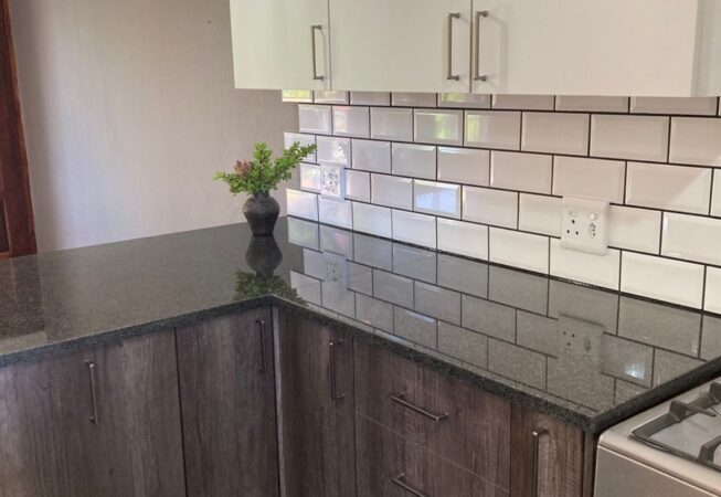 Kitchen revamp using Monument Oak and Folkstone Grey melamine and Rustenburg Granite Tops