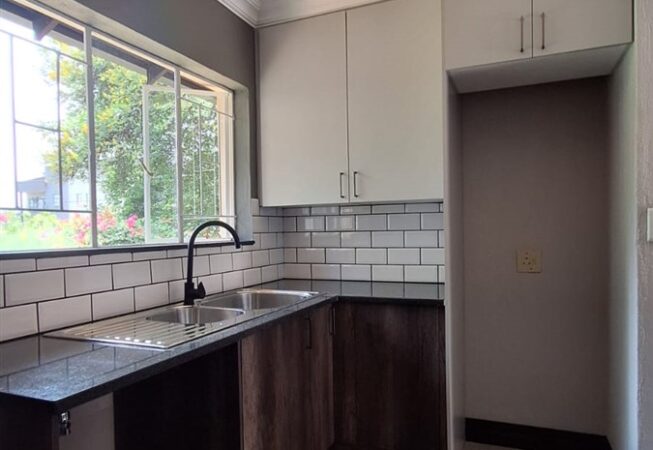 Kitchen revamp using Monument Oak and Folkstone Grey melamine and Rustenburg Granite Tops